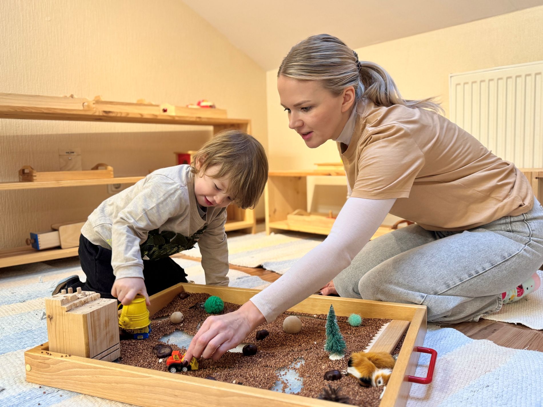 An adult and a child explore the sensory play world together.